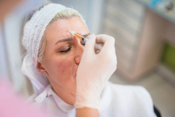 Woman receiving facial treatment in spa