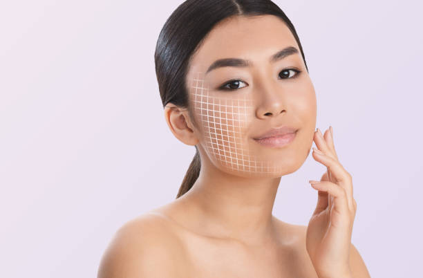 Portrait of a young Asian woman with digital analysis grid on her face for skin assessment